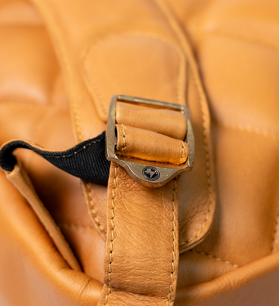 CHARGEO Waterfall Butter tan leather backpack buckle close up view CHARGEO Waterfall Butter tan leather backpack buckle close up view