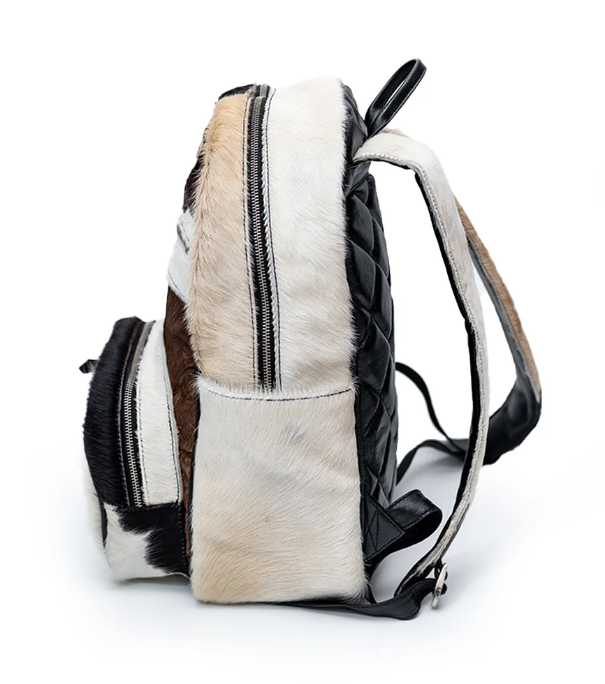 Side view CHARGEO Zulu Treasure Backpack in cowhide with Charcoal and white pattern