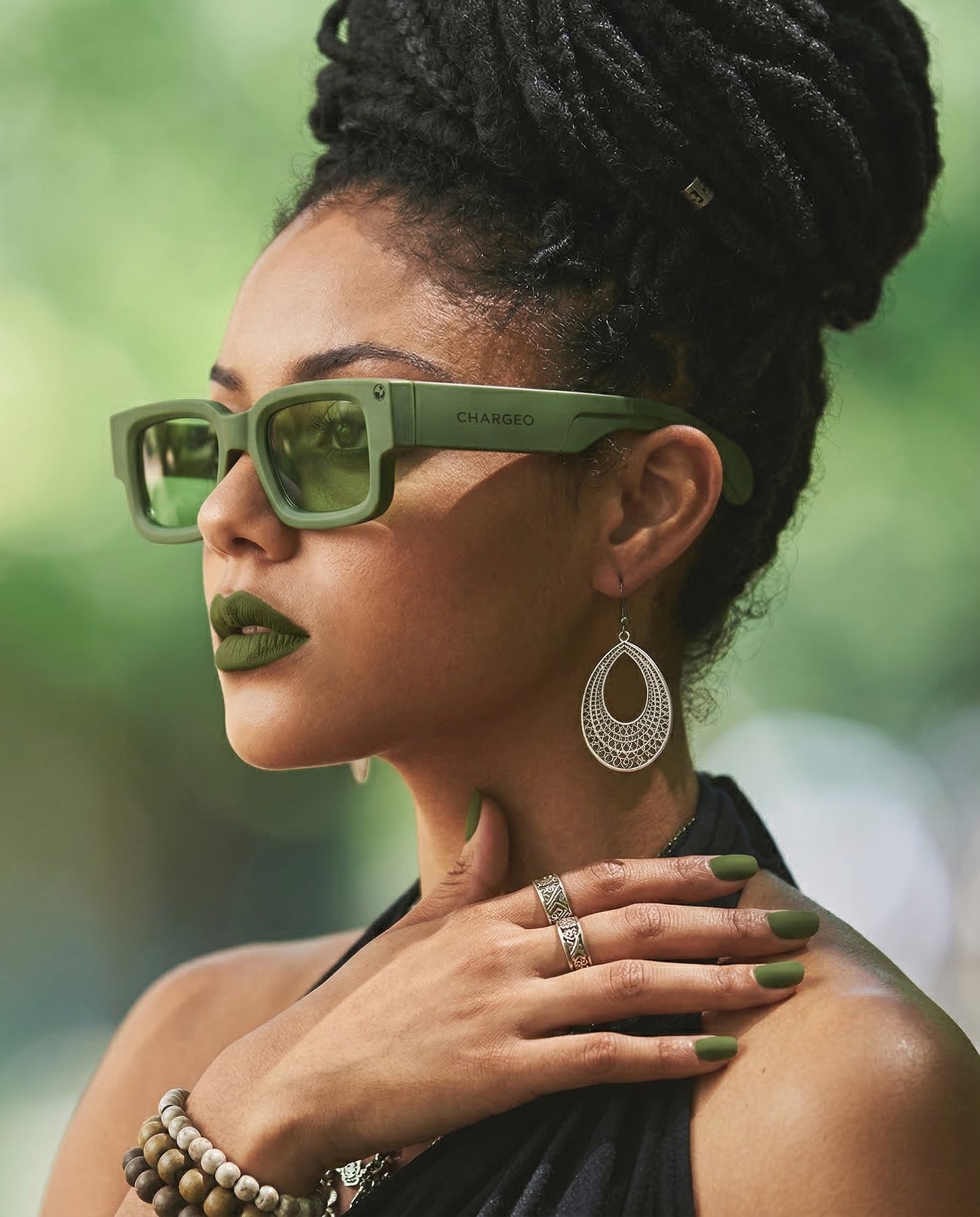 Woman wearing CHARGEO sunglasses with a bold rectangular frame in Avocado