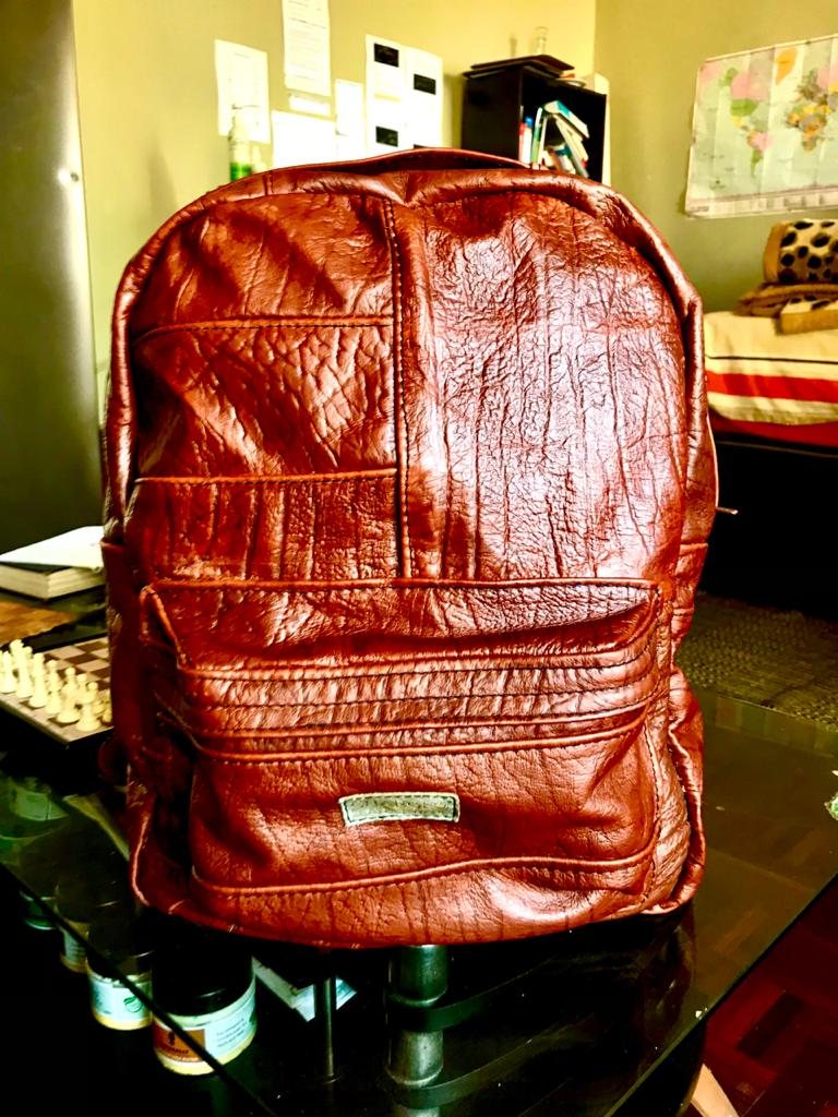 An early CHARGEO oxblood leather backpack on a glass table, June 2021