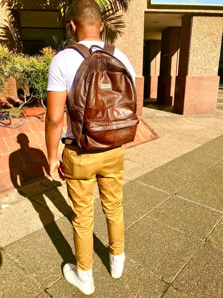 A man wearing an early CHARGEO leather backpack on the street, June 2021