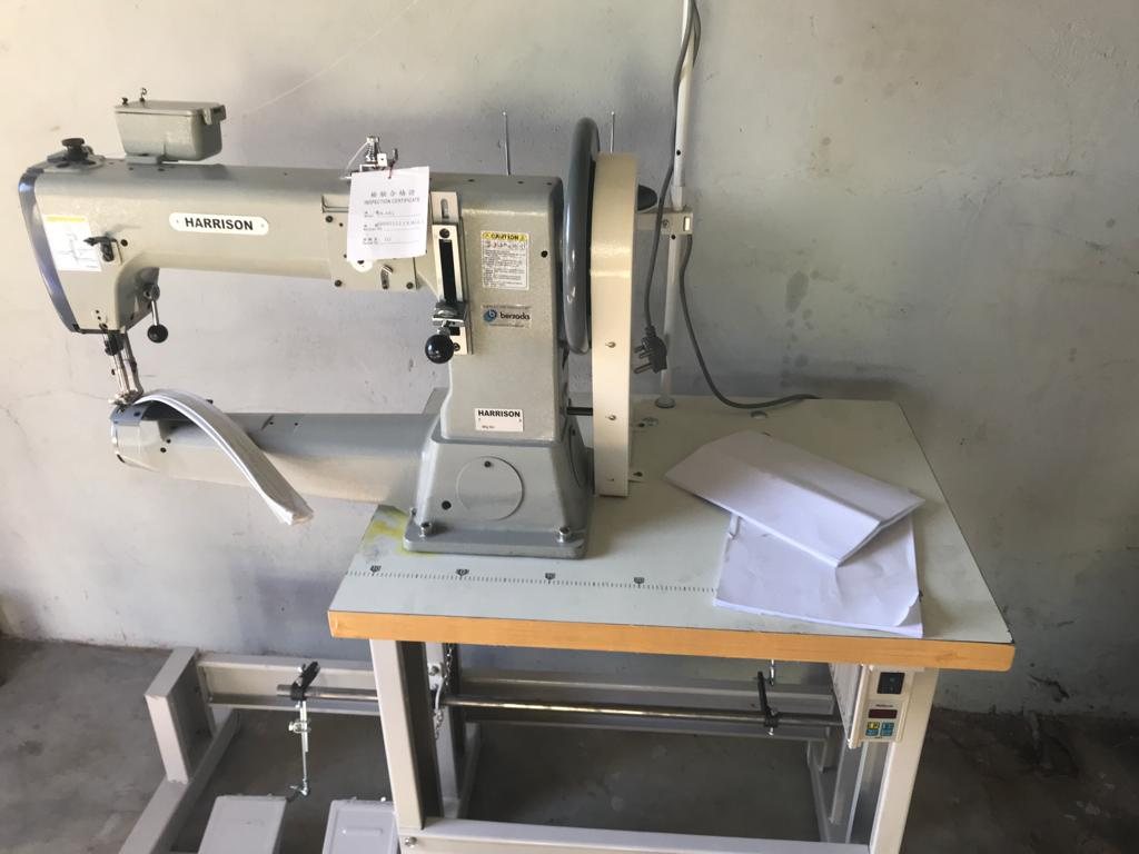 A leather sewing machine on its bench, May 2022